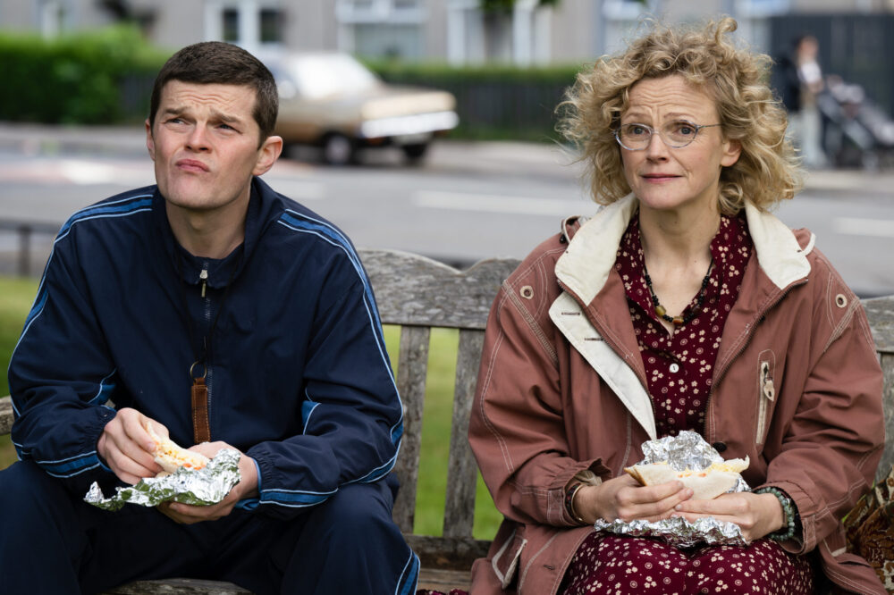 I Swear - cs 28
15.08.24  loc: Riverbank     sc: 114
ext council estate
Dottie tells John to let her know if he isn’t ready as the wait for Karen